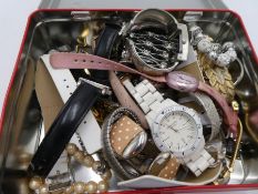 A tin containing modern wristwatches, costume jewellery etc to include a Limit, Avia and Sekonda exa