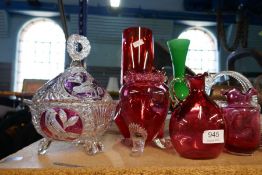 A selection of cranberry glass and a selection of other colours, mostly vases and jugs