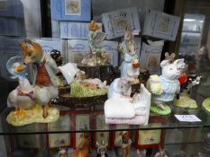 Twelve Royal Albert Beatrix Potter figures and a Beswick tree stamp stand (mainly boxed)