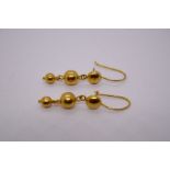 Pair of 18cft yellow drop earrings hung two graduating balls, marked 750, approx 2.7g