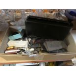 A box of mixed collectables including badges, cut throat razors, lighters, flat ware of a boxed orie