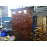 An antique mahogany wardrobe converted from a linen press