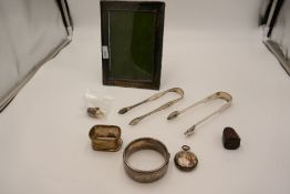 A quantity of items to include two Georgian silver tongs, to include makes Peter and William Bateman