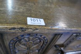 A reproduction oak side cabinet having carved decoration