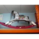 A small painted wooden rocking horse