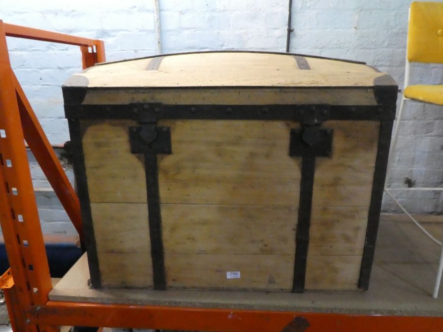 An iron bound wooden trunk with domed top