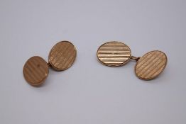 Pair of 9ct yellow gold oval cufflinks with striated decoration, 375, Birmingham, maker C & F