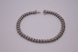 9ct white gold tennis bracelet with 14K white gold catch, maker TJC, marked 375, inset diamond chips