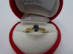 14K yellow gold sapphire dress ring with central oval sapphire and six small diamonds to shoulders,