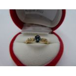 14K yellow gold sapphire dress ring with central oval sapphire and six small diamonds to shoulders,
