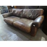 A modern brown leather settee