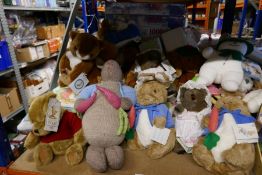 A shelf full of mostly soft toys of Peter Rabbit, Winnie The Pooh and Friends, Jigsaw Puzzles etc