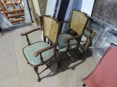 A pair of mahogany open armchairs having cane backs and a gilt framed mirror