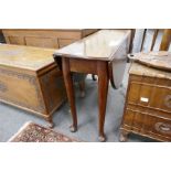 An antique mahogany two flap table on pad feet