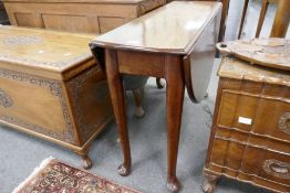An antique mahogany two flap table on pad feet