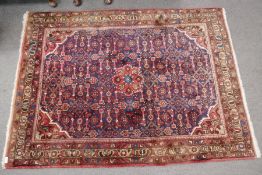 A Hamadan rug, the central field having repeated design, 167 x 121cms