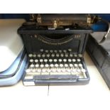A vintage Smith and Corona typewriter and one other