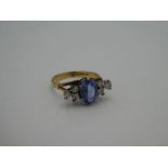 18ct yellow gold seven stone ring set with central oval faceted pale blue sapphire, 9mm x 6mm with t