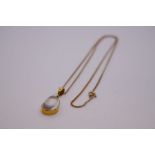 9ct yellow gold neckchain, marked 375, hung with a pendant of a pear shaped moonstone in 14ct gold m