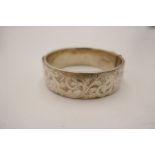 A silver heavy bangle engraved with stylised foliate scroll design. Hallmarked London 1965 Georg Jen