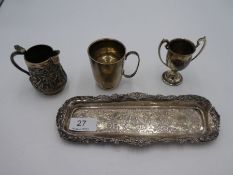 A silver Victorian tray of rectangular form having heavily repoussed design of figures, foliate and