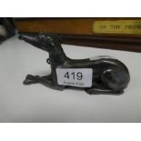 A small spelter lying greyhound stamped JB 13.5cm