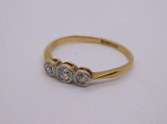 18ct yellow gold diamond trilogy ring in a rubover setting, mounted in platinum, size Q, marked 18ct