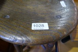 An old oak stool having shaped elm seat