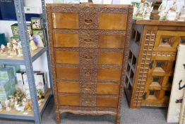 A mid 20th century Indian carved pillar chest of drawers having six drawers, height 105cms