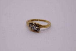 18ct gold cross over design ring with three small diamonds set into platinum, marked 18ct PLAT, AWC