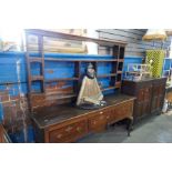 An antique oak dresser with rack back the base having 3 drawers on cabriolet legs, probably early 19