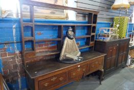 An antique oak dresser with rack back the base having 3 drawers on cabriolet legs, probably early 19