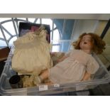 A German antique bisque head doll by AB with additional clothes and similar