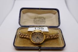 Antique 18ct yellow gold cased watch on expanding plated strap, winds and ticks, marked 18ct London,