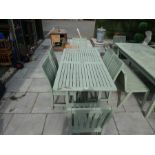 Stained teak table and six non folding chairs