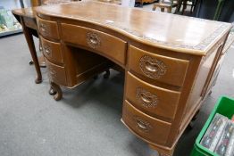 A mid 20th century Indian carved dressing table having shaped front with seven drawers, 106cms