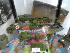 A shelf of die cast military vehicles by Dinky, and a Lone Star