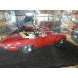 A larger scale model Jaguar E-Type in a glazed display case, and a selection of boxed models includi
