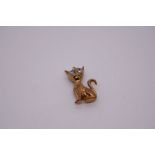 9ct yellow gold charm in the form of a wide eyed cat with pale blue paste set eyes, marked 375, Birm