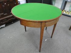 A 19th century cross border mahogany demi lune fold over card table on square tapered legs