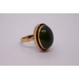 Continental yellow gold ring with large oval cabouchon green hardstone. WWJ, European hallmark, size