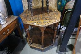 An old carved oak octagonal two tier occasional table and a small carved oak stool