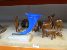 An old blue glass cornucopia on alabaster base and a selection of vintage teak animals