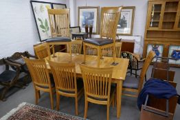 A modern oak oblong dining table having concealed leaf and a set of 10 matching chairs