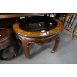 A reproduction oriental style oval coffee table having glass top, 70cm