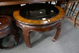 A reproduction oriental style oval coffee table having glass top, 70cm