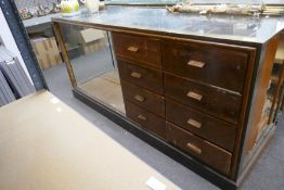 An old Haberdashery shop counter, having 8 drawers beside open shelf with brass decoration, 180cm, a