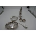 A lot comprising two silver napkin rings, a James Dixon and Sons Ltd trinket dish, a William Henry l