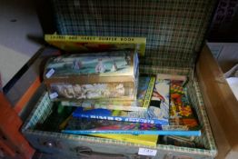 A small suitcase containing Children's books and sundry