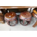 A pair of Chinese hardwood barrel shaped stands, 46.5cm